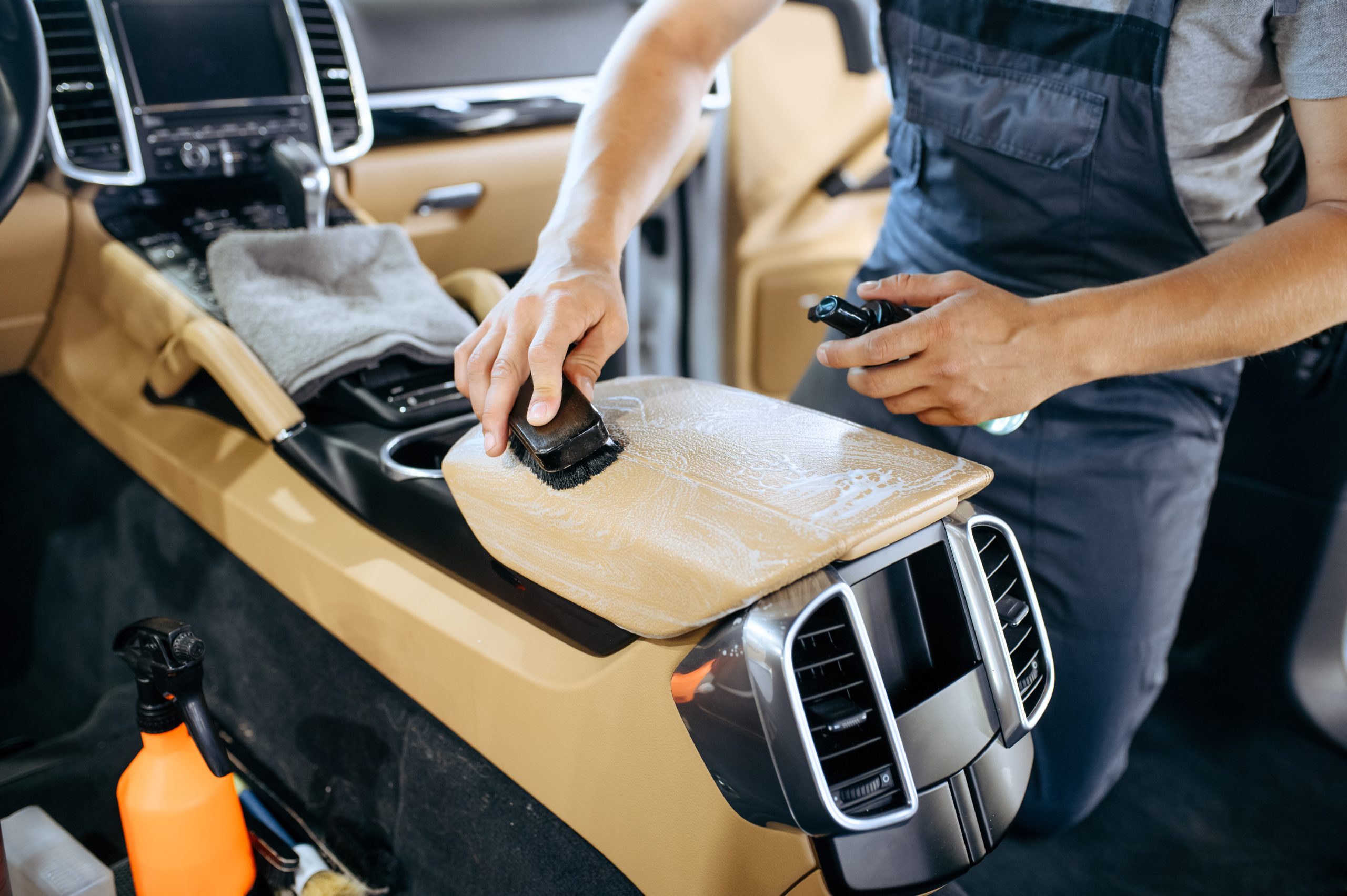 worker-with-brush-wipes-car